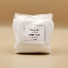 Load image into Gallery viewer, Bag of citric acid with a label on a beige background
