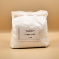 Bag of Epsom salts with a label on a beige background