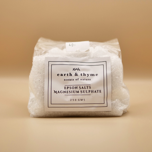 Packaged Epson salts with 'earth & thyme' label on a beige background