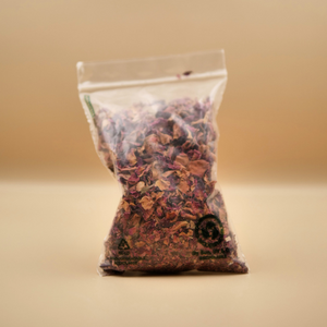 Clear plastic bag with dried herbs on a beige background