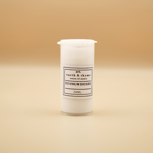 Small container of titanium dioxide with a label on a beige background